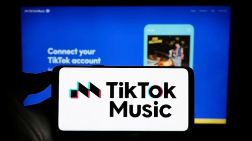 Stuttgart, Germany, 07-30-2023: Person holding cellphone with logo of streaming service TikTok