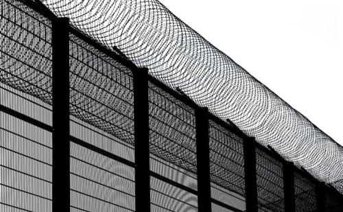 High fence and barbed wire, concertina wire, Nato barbed wire at Mainkofen District Hospital,
