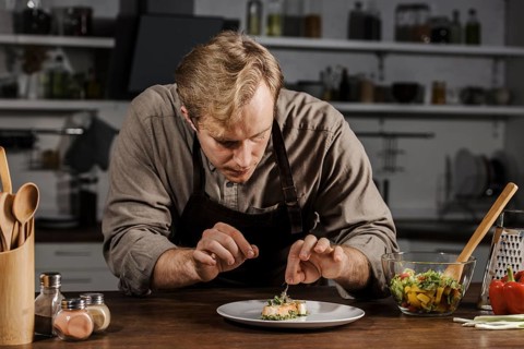 Mid shot chef plating dish