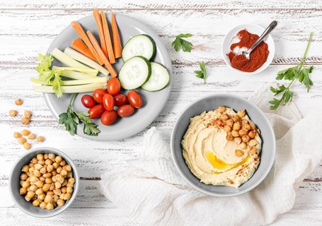 Top view vegetables with hummus