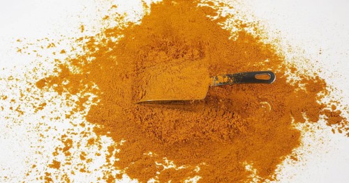 Curry Powder falling against white background