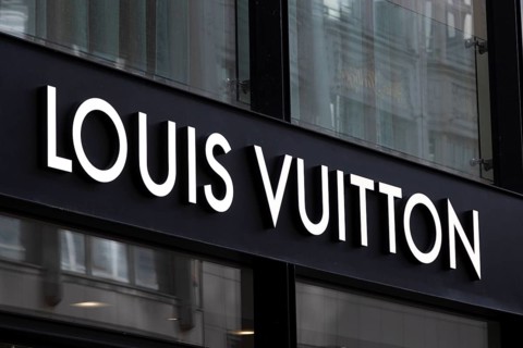 Close-up, logo of the French luxury fashion brand Louis Vuitton on a boutique in the shopping