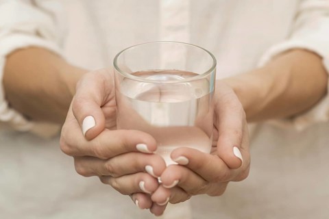 Woman holding glass filled with water. Resolution and high quality beautiful photo