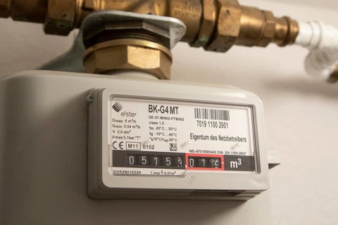 Symbolic image of energy costs in the household, natural gas, analogue gas meter in a flat,