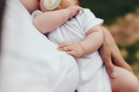 Little baby's hands, mother with baby, care of baby, mother carrying baby.