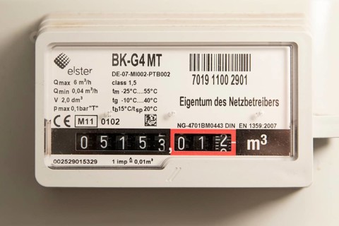 Symbolic image of energy costs in the household, natural gas, analogue gas meter in a flat,