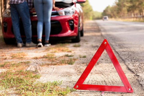 Red triangle sign road car problems while traveling