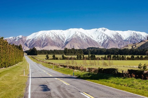 The view along a highway towards Mt Hutt in the Canterbury countryside of New Zealand