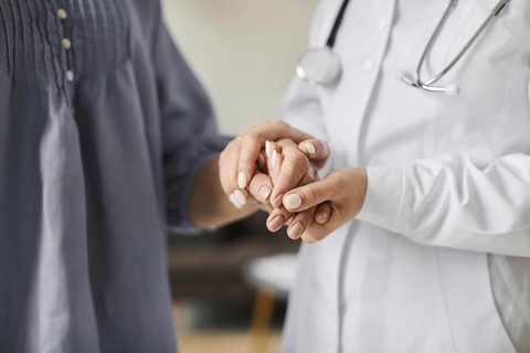 Covid recovery center female doctor holding elderly patient s hands. High resolution photo