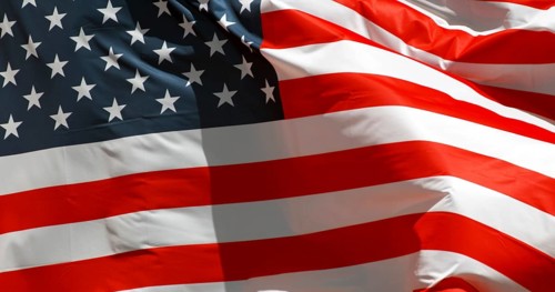 American Flag Waving in the Wind against blue sky
