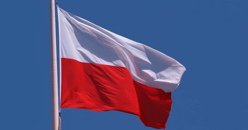 Polish Flag Waving in the Wind against blue sky