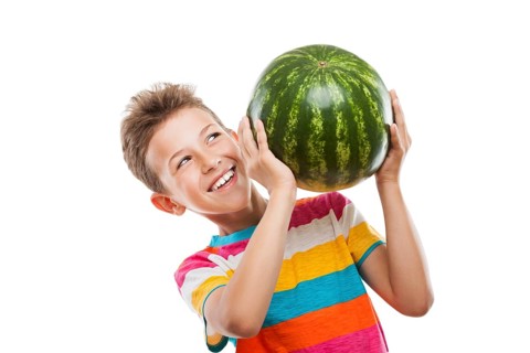 Handsome smiling child boy hand holding green ripe watermelon fruit food white isolated