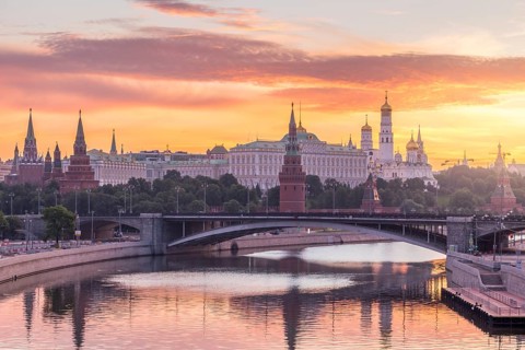 Moscow Kremlin and Moscow River with bridge in the summer sunny morning. Colorful sky. Russia