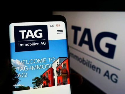 Stuttgart, Germany, 05-21-2022: Person holding smartphone with website of German real estate