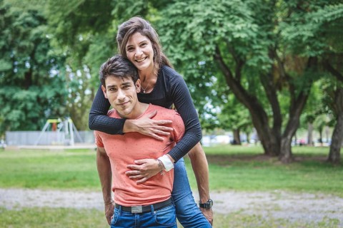 Boyfriend carrying his girlfriend on piggyback