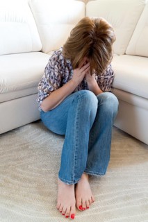 Woman crying covering her face with a hands