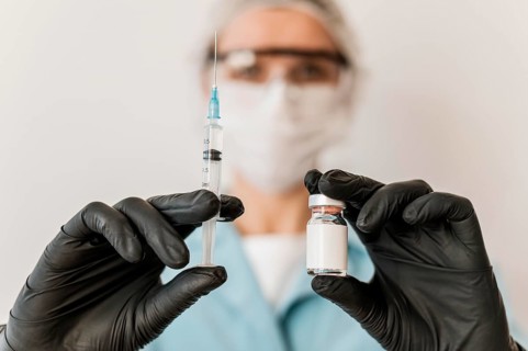 Front view female doctor with vaccine gloves