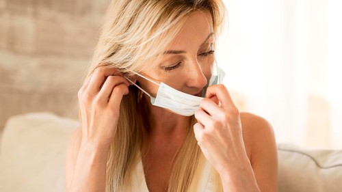 Mother putting medical mask protection