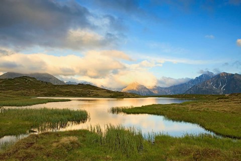 Cloudy sky at Jaufenpass, Passo di Monte Giovo, mountain lake, evening mood, Sterzing, South Tyrol,