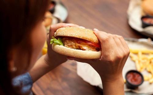 High angle woman eating burger