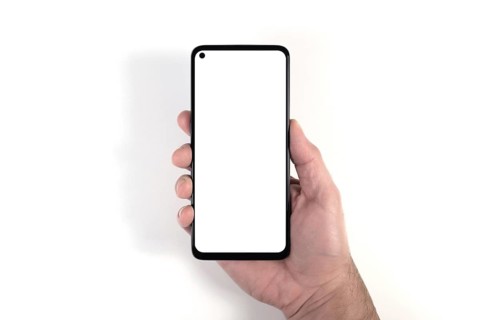 hand holding smartphone with blank white screen against white background, person using smartphone