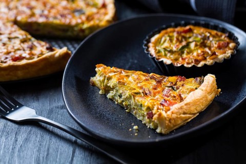 Quiche Lorraine - traditional French tart with pastry crust filled with bacon and leek
