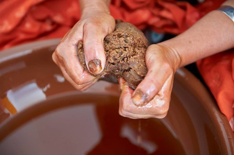 Argan oil being squeezed out of the Argon paste. Cooperative Marjana, Ounara, Essouira, Morocco,