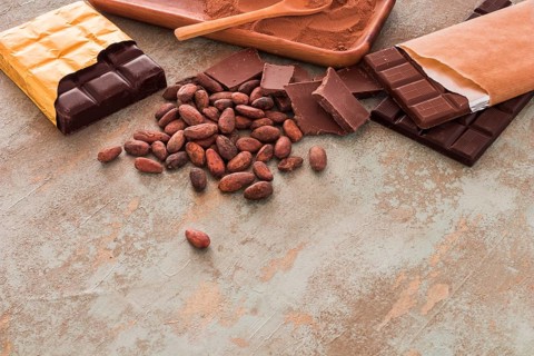 Chocolate bars cocoa beans powder grunge background