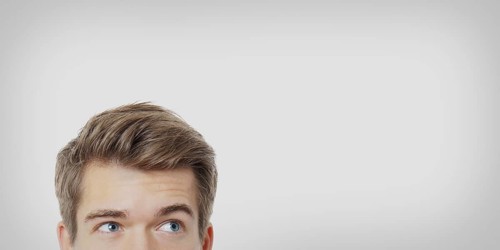male eyes looking up towards copy space