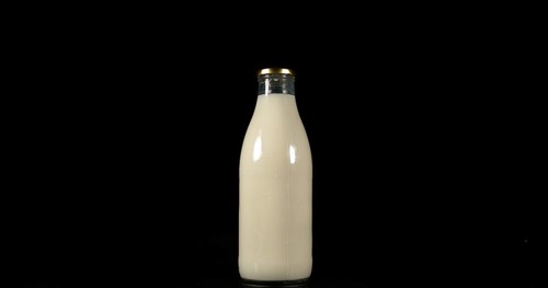Bottle of Milk against Black Background