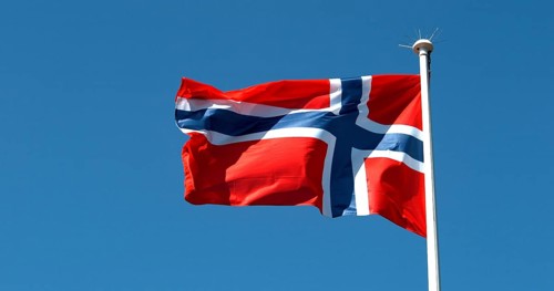 Norvegian Flag Waving in the Wind against blue sky