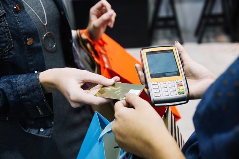 Anonymous woman paying shop. High resolution photo