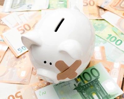 Broken piggy bank standing money