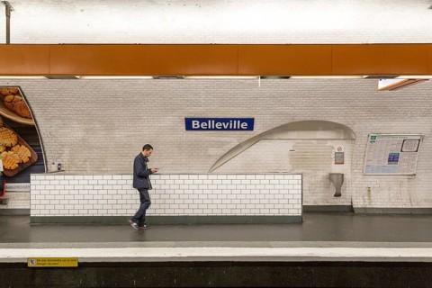 Paris, France, May 12, 2017: A man walking past a sign at Belleville Metro station, Europe