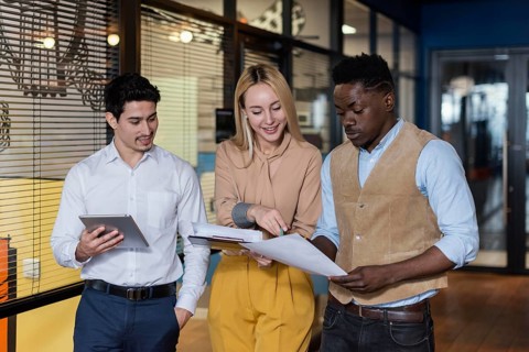 Smiley coworkers looking documents together