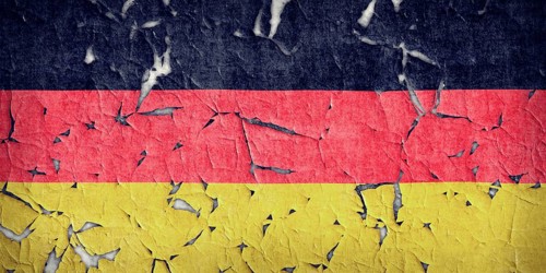 Wall paint of Germany flag is peeling off. Wall with painted Germany flag is peeling off