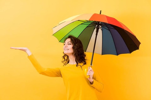 Front view woman with rainbow umbrella