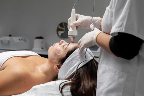 Young woman having facial treatment