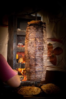 Traditional Turkish food Doner Kebab. Turnspit skewing kebap kebab shawarma