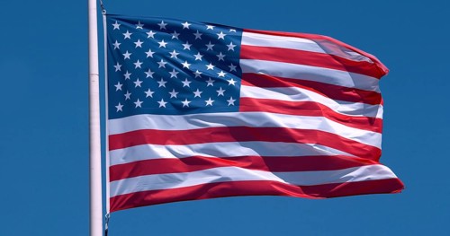 American Flag Waving in the Wind against blue sky