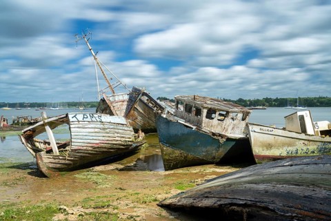 Pin Mill, England - 11 June, 2022: view of the boat graveyard at Pin Mill on the River Orwell in