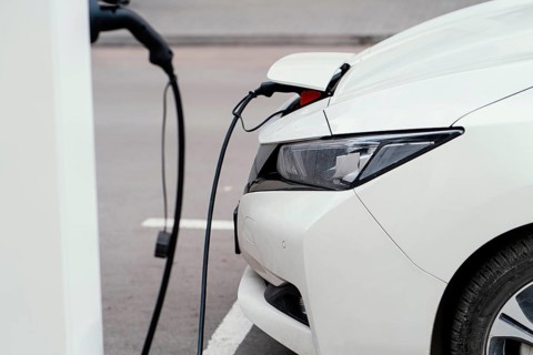 Side view automobile being charged electric vehicle charging station. Beautiful photo