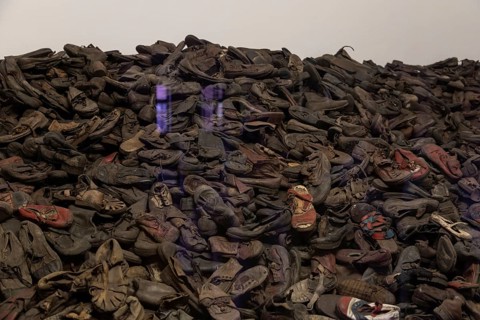 A picture of an exhibit inside the Memorial and Museum Auschwitz I that shows a collection of shoes