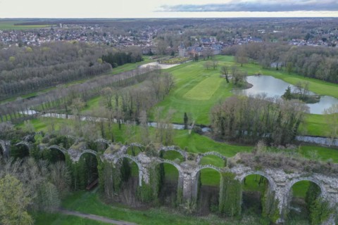 Aerial view of Chateau de Maintenon on the Eure river with golf course and ruins of the aqueduct,