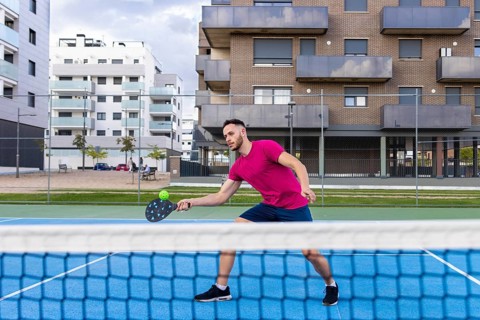 Young Man Pickleball Player Playing Pickleball in Court