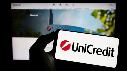 Stuttgart, Germany, 06-17-2023: Person holding mobile phone with logo of Italian financial company