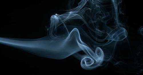 Smoke of Cigarette rising against Black Background