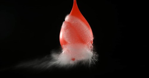 Shot Breaking Water Filled Red Balloon
