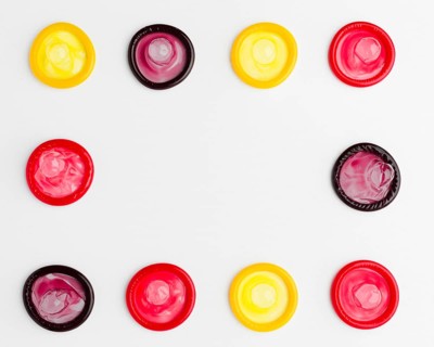 Flat lay arrangement colorful condoms with copy space