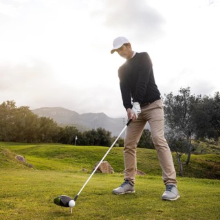 Man playing golf field with club